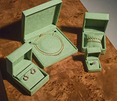 Signature gift packaging with jewelry boxes and ribbon